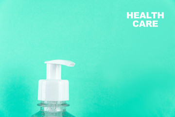 Container with alcohol gel on the light blue background