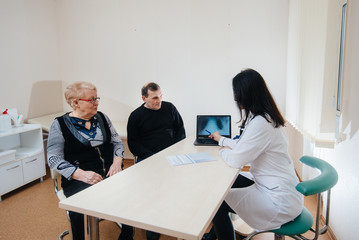 A couple of elderly people at a personal doctor's appointment at a medical center. Medicine and healthcare