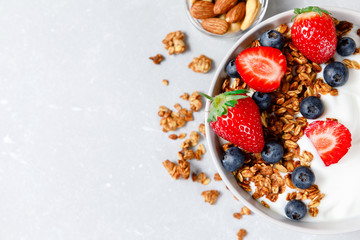Fototapeta na wymiar Homemade oatmeal granola bowl with greek yogurt, berries, honey and nut