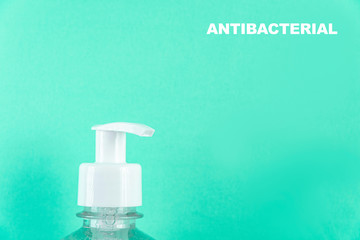 Container with alcohol gel on the light blue background