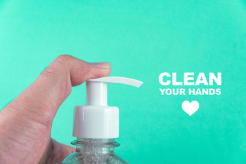 Man hand in container with alcohol gel on the light blue background