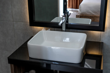 The photo of a sink and mirror in a bathroom