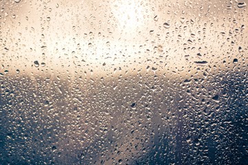 Raindrop window in a rainy and sunny sunset