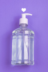 Container with alcohol gel on the light blue background