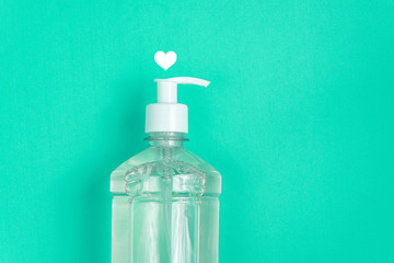 Container with alcohol gel on the light blue background