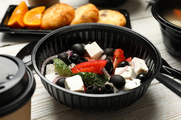 Food delivery. Food in takeaway boxes on wooden table