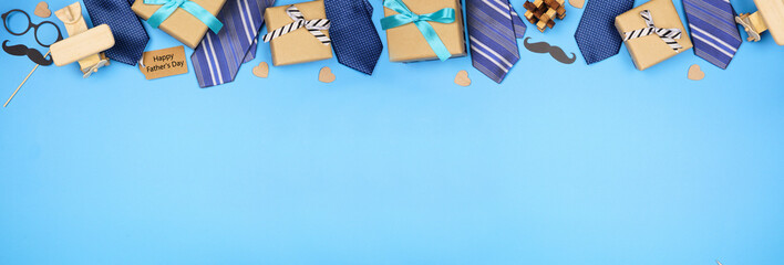 Happy Fathers Day gift tag with long border of ties, gifts and games on a blue banner background....