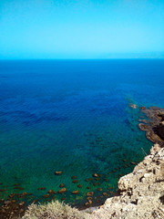 Blue-turquoise sea from the height of the mountain. Beautiful summer landscape.