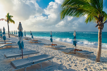 colorful tropical sunset on Anguilla island Caribbean sea with palm trees and ocean waves