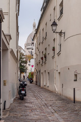 a little quiet street in Montmartre, with the Sacré coeur at the end of it