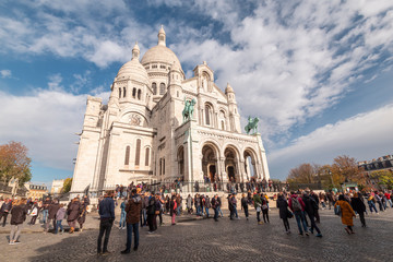 the white basilique of the sacré coeur, standing up the hill of Montmartre, Paris, with people at the front