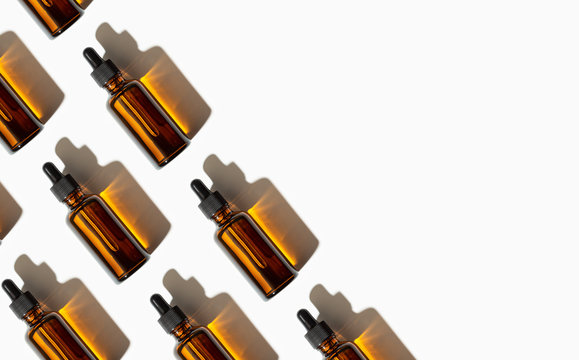 Essential oil or serum glass bottle pattern isolated on white background. Copy space