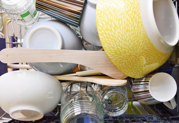 Cleaned dishes in dishwasher rack top view.