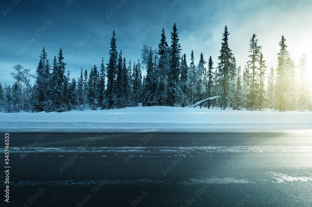 Sticker road in winter forest, sunset time