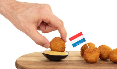 Dutch traditional snack bitterbal in a hand