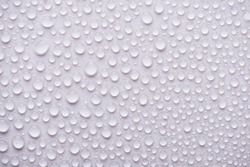 Overhead view photo of water drops on the white background