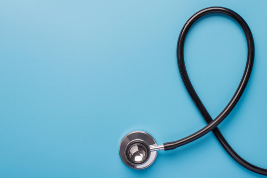 November month charity mental problem research insurance concept. Flat lay top above overhead close up view photo of black stethoscope isolated on blue background with empty space