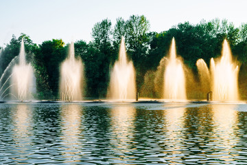 Vinnitsa, Ukraine. Fountains show with music and color. Fountains splashing on the river. Dancing fountains on a beautiful summer evening