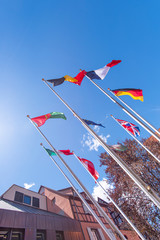 Flags of EU, Great Britain, France, Italy, Germany, Belgium and another countries on flagpoles in Strasbourg, France