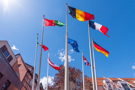 Flags of EU, Great Britain, France, Italy, Germany, Belgium and another countries on flagpoles in Strasbourg, France