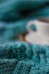 Сup of hot tea and warm hand knitted blanket