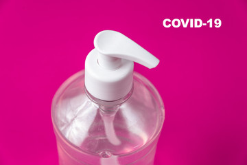 Container with alcohol gel on the red background