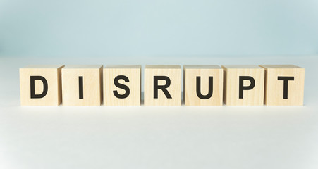 DISRUPT word on wooden cubes on a light background