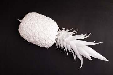Pineapple in white paint on black background.