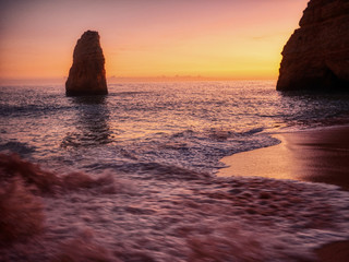 Sunset in front of the big lonely rock. Algarve, Portugal.