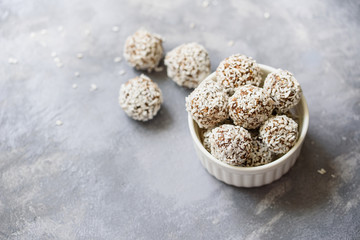 Healthy raw energy balls with cocoa, coconut, sesame, chia on white background. Healthy homemade...