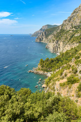 Fototapeta na wymiar The sea, cliffs and rocks on Italy's Amalfi coast. The Amalfi Drive is a popular tourist trip.