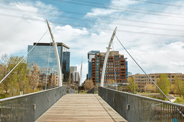 South Platte River Bridge, surrounded by modern apartments and office buildings in Commons Park .  Denver, Colorado