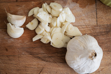 Top view of garlic bulb next to chopped garlic cloves