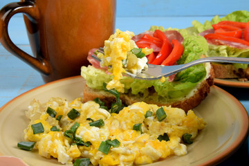 scrambled eggs with chives on a fork