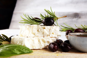 Greek cheese feta with rosemary and olives. Healthy ingredient for cooking salad. Chopped Goat feta cheese with gourmet herbs - obrazy, fototapety, plakaty
