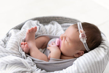 newborn baby sleeps with pacifier