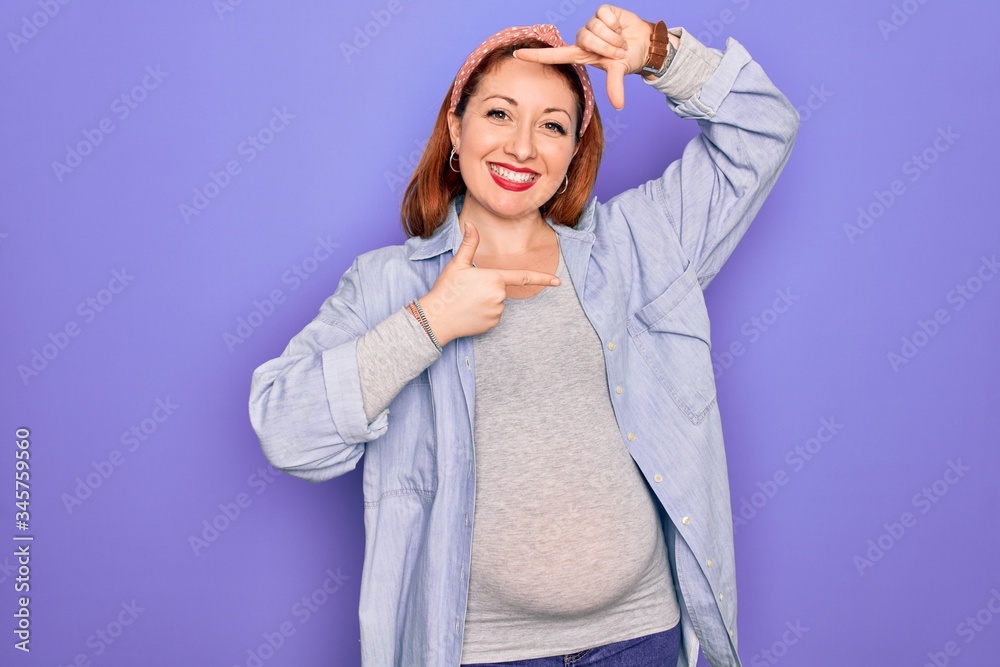 Sticker Young beautiful redhead pregnant woman expecting baby over isolated purple background smiling making frame with hands and fingers with happy face. Creativity and photography concept.