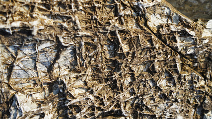 Stone texture, volcanic rock structure layers. geometric natural composition of different minerals in the stone. flat lines, unusual shape of the surface of volcanic rocks