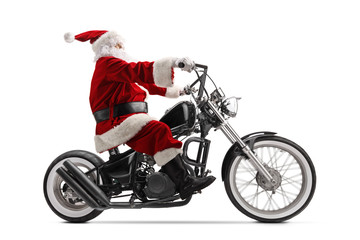 Full length profile shot of Santa Claus riding a custom chopper motorbike