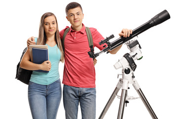 Male and female students posing with a telescope