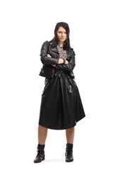 Young woman in black leather jacket and skirt posing with crossed arms