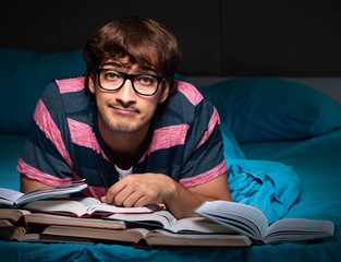 Young student preparing for exams at night at home