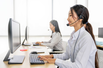 Asian operator woman working in a call center, Female technical support answering customer...