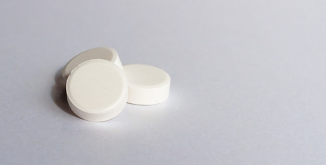 Tablets in blister and gray bottle antiseptikum lies on the steel. Place for the label.Medical topic.