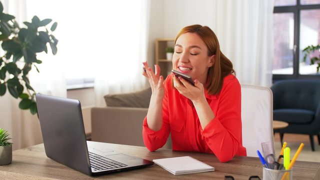 remote job, technology and people concept - angry young woman with laptop computer calling on smartphone at home office