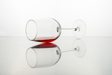 Glass of red wine on a transparent white surface