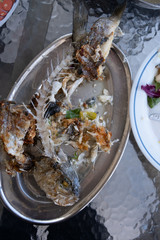 Leftovers of sea bream seafood on a plate