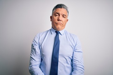 Middle age handsome grey-haired business man wearing elegant shirt and tie looking sleepy and tired, exhausted for fatigue and hangover, lazy eyes in the morning.