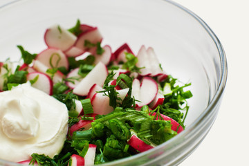 salad of radish, green onions, dill and parsley, on a white background. healthy eating concept