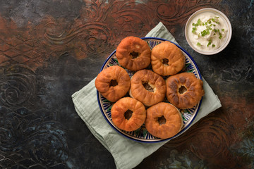 Tatar pies with meat roasted on a beautiful background with sour cream